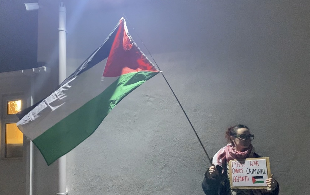 Protestor stands outside community building in solidarity of the Palestinians