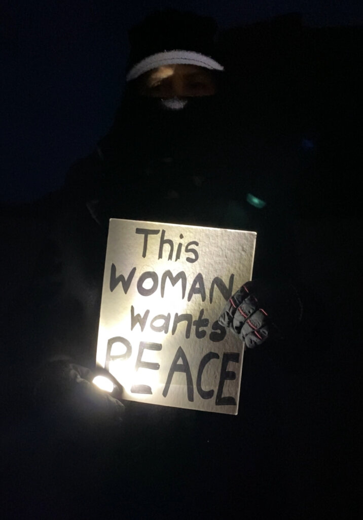 A woman displays a peace sign in support of Palestinians